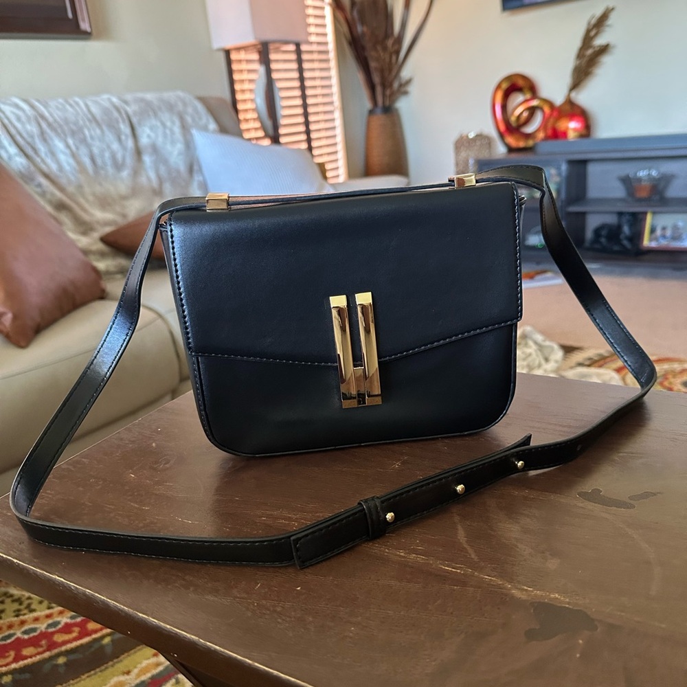 Black bag with gold double bar hardware